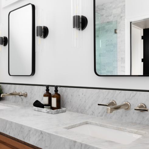 Black and white bathroom marble counter featuring an 8 foot long tile trim edge